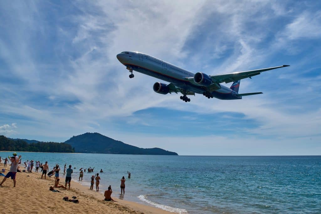 Plane flying over beach